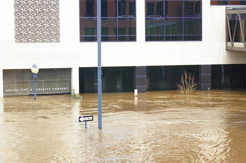 The main door of the 118 Building with flood waters above the level of the door